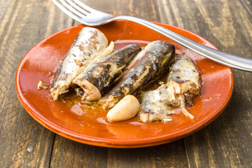 sardines appetizer earthenware dish on wood