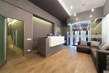 Lobby entrance with reception desk in a dental clinic.