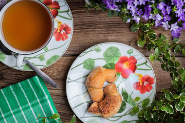Breakfast with croissants, cup of tea.