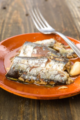 sardines appetizer earthenware dish on wood