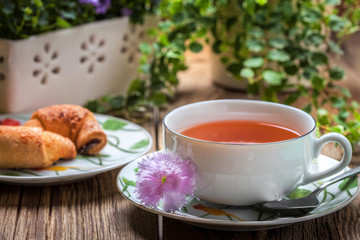 Breakfast with croissants, cup of tea.