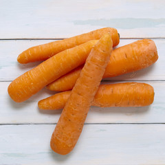 Carrots on a rustic painted wood background