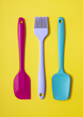 Kitchen cooking utensils on a yellow background
