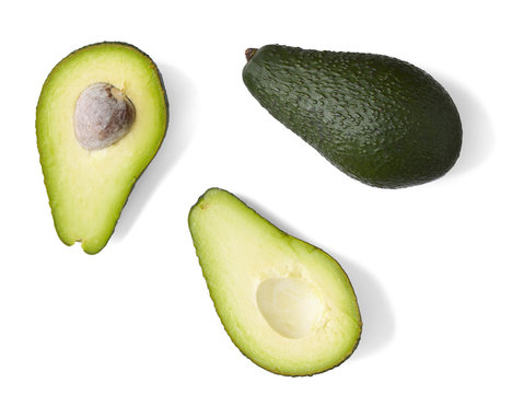 whole and half avocados isolated on a white background
