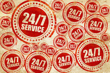 Obraz premium 24/7 service, red stamp on a grunge paper texture