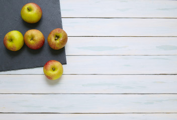 Apples on a slate board and wooden counter top