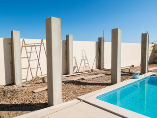 The pillars of a pool side pergola during construction.
