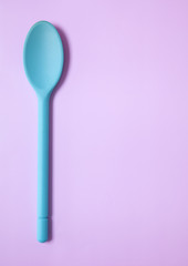 Cooking spoon border on a purple background