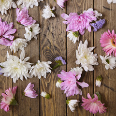 Flower heads scattered on a wooden background