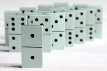a bunch of dominoes lying on a white wooden background