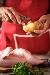 Unrecognizable woman cooking chicken