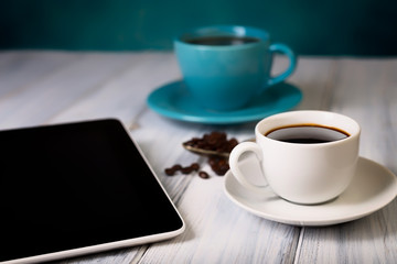 Coffee and tablet on the table