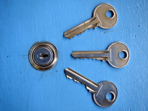 Keys and a keyhole on a blue door