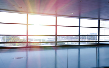 Fototapeta na wymiar Modern airport interior glass wall aisle window