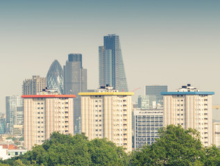Fototapeta na wymiar City of London skyline over green trees