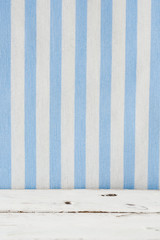 White wooden floor with blue and white stripes background
