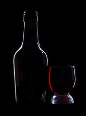 Wine bottle and glasses on black background
