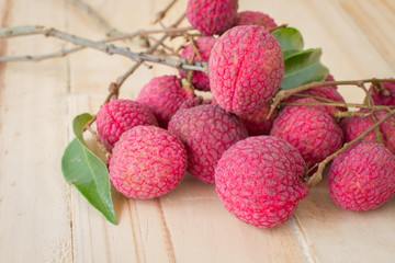 big red Lychee on wood table background, selective focus