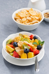 bowl of fresh fruit salad with corn flakes, vertical