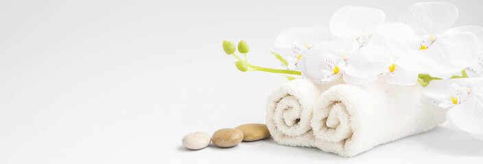 Plakat Spa orchid with soft towels and massage stones setting