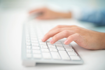 Image of woman's hands typing. Selective focus
