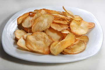 Potato chips isolated on white plate