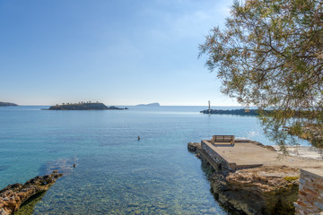 Beautiful beach in Syros, Cyclades, Greece. Deep blue sea and br