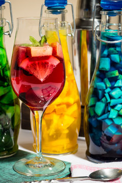 summer fruit painted cocktails, lemonade, wine in glass, studio photo