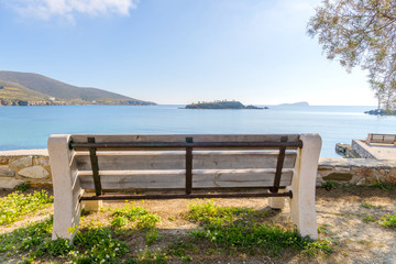 Fototapeta na wymiar Traditional bench by the sea in Syros, Cyclades, Greece.