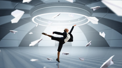 Fototapeta premium Dancing businesswoman in office