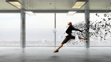 Dancing businesswoman in office