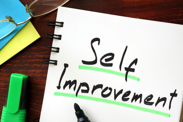 Self improvement sign written in a notepad.