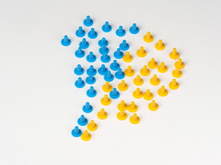 Two groups coming together illustrated by coloured plastic board game hats in various colours, Melbourne 2016