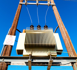 in oman the electric cable wood pylon energy and current line