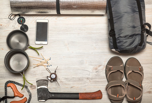 Overhead view of hiking gear on a wood floor. Gear include