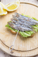 Sandwich with sardines, sprats with parsley and dill