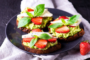Fresh toast with strawberry on black plate