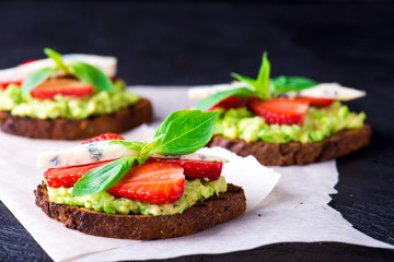 Sandwich with strawberry on white paper