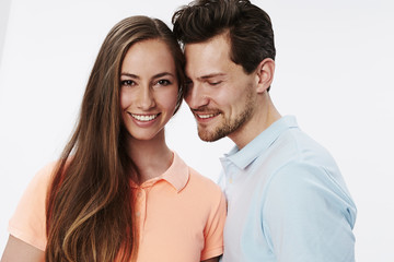 Happy smiling couple in white studio