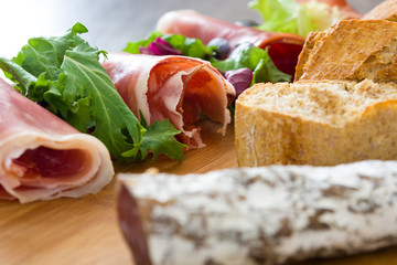 Spanish serrano ham, olives and sausages
on wood