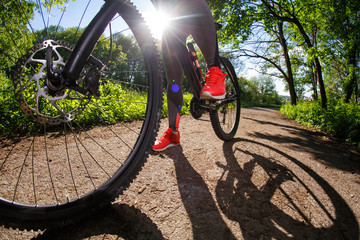 Young woman having fun riding a bicycle in the park.