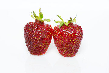Two strawberries on the white background