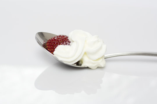 Strawberry with whipped cream on the white background
