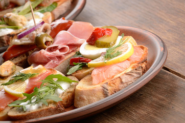 Open sandwiches with salmon, eggs, mussels, jamon and herring