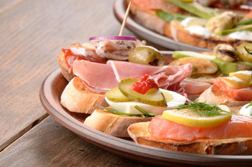 Open sandwiches with salmon, eggs, mussels, jamon and herring