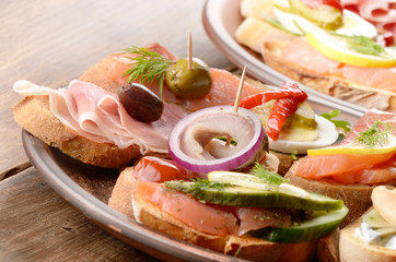 Open sandwiches with salmon, eggs, mussels, jamon and herring