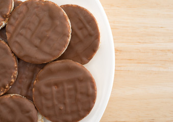 Organic rice cookies with milk chocolate icing on plate