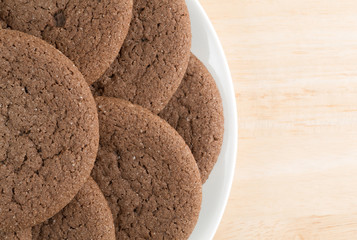 Plate of Dutch cocoa cookies on a wood table top