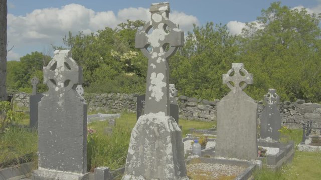 Celtic cross in an Irish graveyard, County Clare, Ireland. Flat video profile.