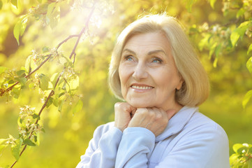 Senior woman in green park